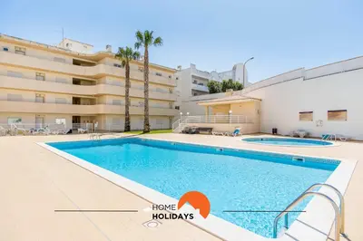 a swimming pool in front of a building at #115 Bernardo Flat by Home Holidays in Albufeira