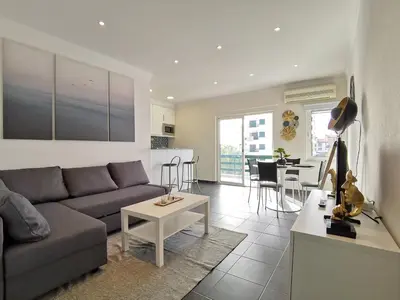 a living room with a couch and a table at Vilamoura Neptuno in Quarteira