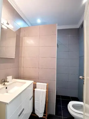 a bathroom with a sink and a toilet at Vilamoura Neptuno in Quarteira