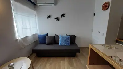 a couch in a room with bats on the wall at AZULEJOS em VILAMOURA PORTUGAL in Vilamoura