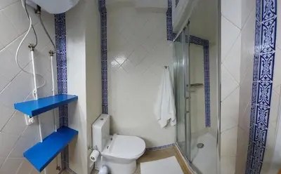 a bathroom with a toilet and a shower at AZULEJOS em VILAMOURA PORTUGAL in Vilamoura