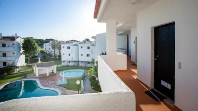 a balcony with a view of a pool and buildings at Terraços do Mar Apartment W/ Pool by LovelyStay in Vilamoura