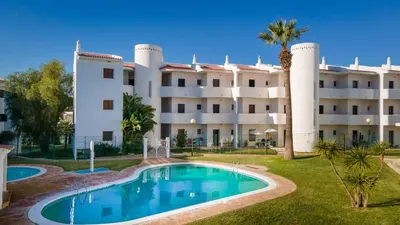 a building with a swimming pool in front of a building at Terraços do Mar Apartment W/ Pool by LovelyStay in Vilamoura