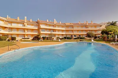 a large swimming pool in front of a large building at Palm Beach Apartment in Vilamoura