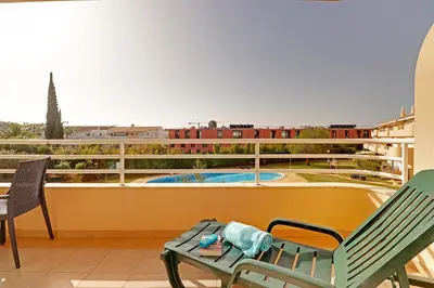 a view of a swimming pool from a balcony of a building at Palm Beach Apartment in Vilamoura