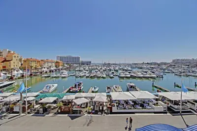 a beach with a bunch of umbrellas and the ocean at Palm Beach Apartment in Vilamoura