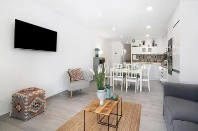a living room with a couch and a table at Apartamento Acácia in Vale do Lobo