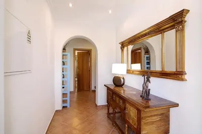 a room with a wooden dresser and a mirror at Villa Formosa in Almancil