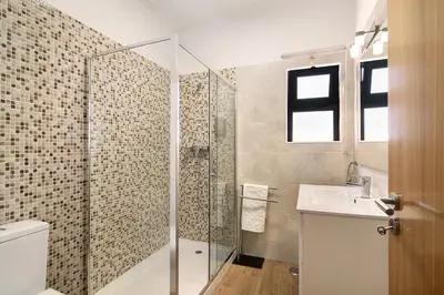 a bathroom with a shower and a sink at Villa Formosa in Almancil