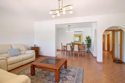 a living room with a couch and a table at Villa Formosa in Almancil