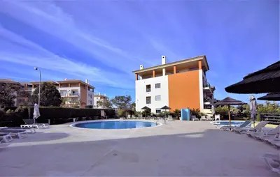 a swimming pool in front of a building at Luxury Apartment with Pool in Albufeira