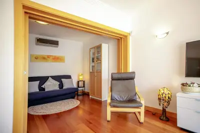 a living room with a blue couch and a chair at Luxury Apartment with Pool in Albufeira