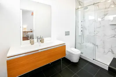 a bathroom with a sink and a shower and a toilet at Watermelon Sugar Apartment in Faro