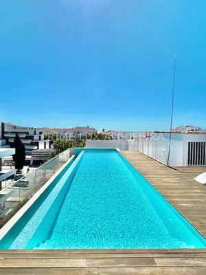 a swimming pool on the roof of a building at Prime Lux Albufeira in Albufeira