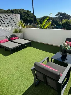 a patio with two couches and a green rug at Beautiful apartment set in the heart of Quinta - Newly Refurbished in Almancil