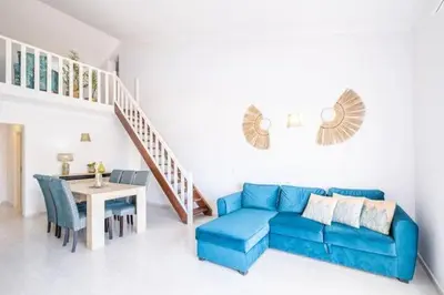 a living room with a blue couch and a table at Apartment Maria - Complex with tennis court and restaurant,pool in Albufeira