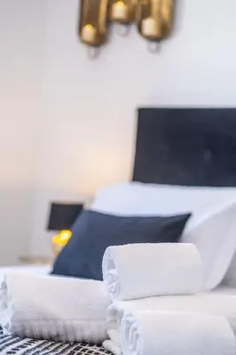 a pile of towels sitting on top of a bed at Apartment Maria - Complex with tennis court and restaurant,pool in Albufeira