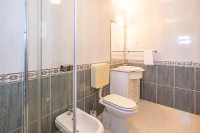 a bathroom with a toilet and a sink and a shower at Apartment Maria - Complex with tennis court and restaurant,pool in Albufeira