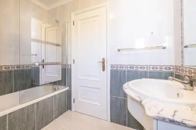 a white bathroom with a sink and a tub and a sink at Apartment Maria - Complex with tennis court and restaurant,pool in Albufeira