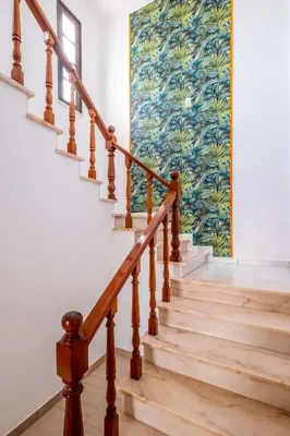 a staircase with wooden railings and a painting on the wall at Patroves Ranch - private pool & sea views in Albufeira