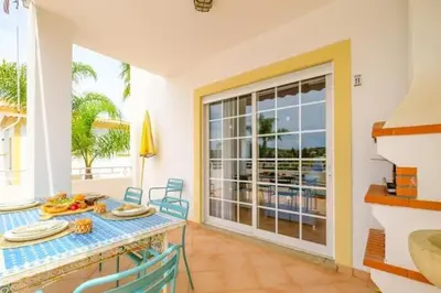 a dining room with a table and a view of the ocean at Apartment Esta - Tennis court and pool in Albufeira