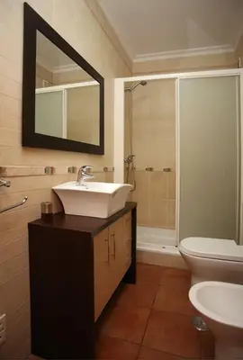 a bathroom with a sink and a toilet and a mirror at Villa Arade - Complex ideal for families in Albufeira