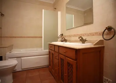 a bathroom with a sink and a tub and a toilet at Villa Arade - Complex ideal for families in Albufeira