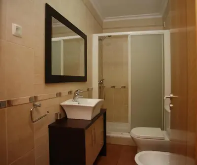 a bathroom with a sink and a toilet and a mirror at Villa Arade - Complex ideal for families in Albufeira