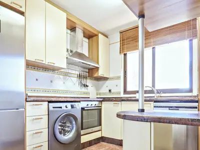a kitchen with a washing machine and a sink at Falésia's Harmony -5min to the beach by LovelyStay in Albufeira