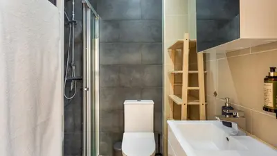 a bathroom with a shower and a toilet and a sink at Sweet As by LovelyStay in Quarteira