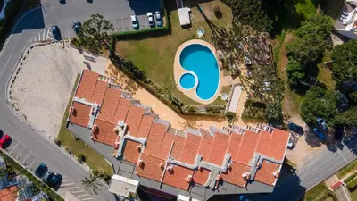 an overhead view of a building with a swimming pool at Sweet As by LovelyStay in Quarteira