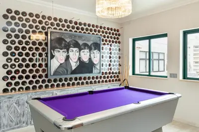 a pool table in a room with a painting at Seaview & Sunsets Apartment in Quarteira