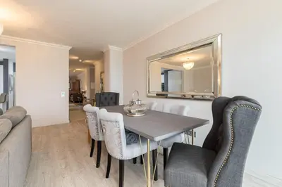 a dining room with a table and chairs at Seaview & Sunsets Apartment in Quarteira