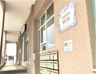 a building with a sign on the side of it at Beach Lover's Paradise: 3BR 2 min from the Sand in Quarteira
