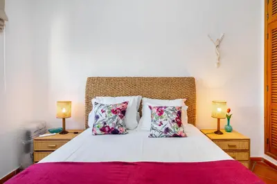 a bedroom with a white bed with pillows and two lamps at Family Apartment Pool & Terrace in Vilamoura
