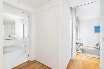 a white apartment with white walls and wood floors at Villa Jasmim by OCvillas in Albufeira