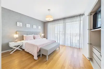 a bedroom with a large bed and a window at Villa Jasmim by OCvillas in Albufeira