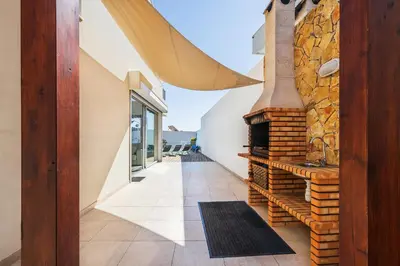 a hallway of a house with a brick fireplace at Villa Jasmim by OCvillas in Albufeira