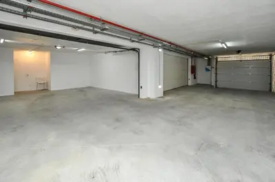 an empty room with a garage with a garage door at Villa Jasmim by OCvillas in Albufeira