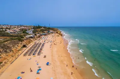 a group of people on a beach with the ocean at Villa Farol by OCvillas in Galé