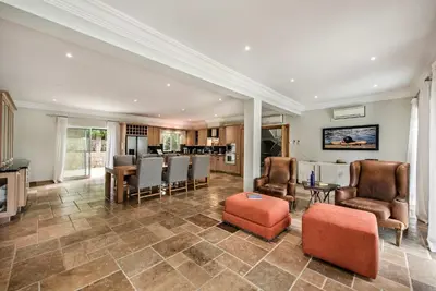an open living room with chairs and a kitchen at Villa Millennium luxury villa relaxing location in Almancil
