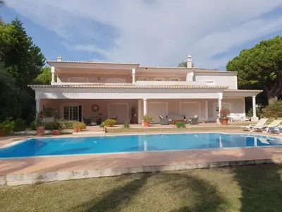 a villa with a swimming pool in front of a house at Villa Zarana fantastic house in Salinas in Faro