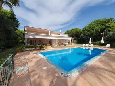 a swimming pool in front of a house at Villa Zarana fantastic house in Salinas in Faro