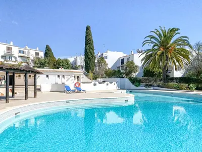 a swimming pool in a villa with trees and buildings at Lovely Apartment in Albufeira 2BD 250m Beach Ocean view and AC Wi-Fi Pool in Albufeira