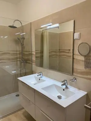 a bathroom with a sink and a shower and a mirror at Cozy apartment near Oura Beach in Albufeira