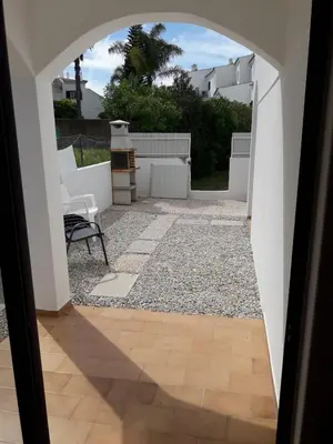 a view of a patio through an archway at Cozy apartment near Oura Beach in Albufeira