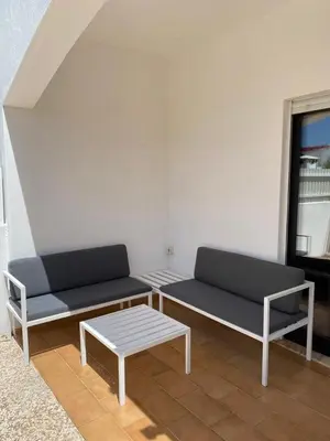 two benches and a coffee table in a room at Cozy apartment near Oura Beach in Albufeira