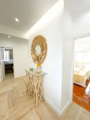 a room with a table with a mirror and a bed at So Sweet Center of Faro Flat in Faro