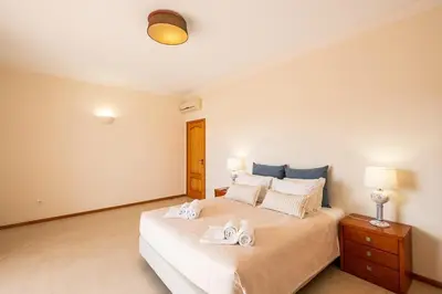 a bedroom with a bed with two towels on it at Villa Gale Grande - bright airy property with a private pool in Albufeira