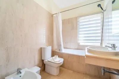 a bathroom with a toilet and a sink and a mirror at Villa Gale Grande - bright airy property with a private pool in Albufeira